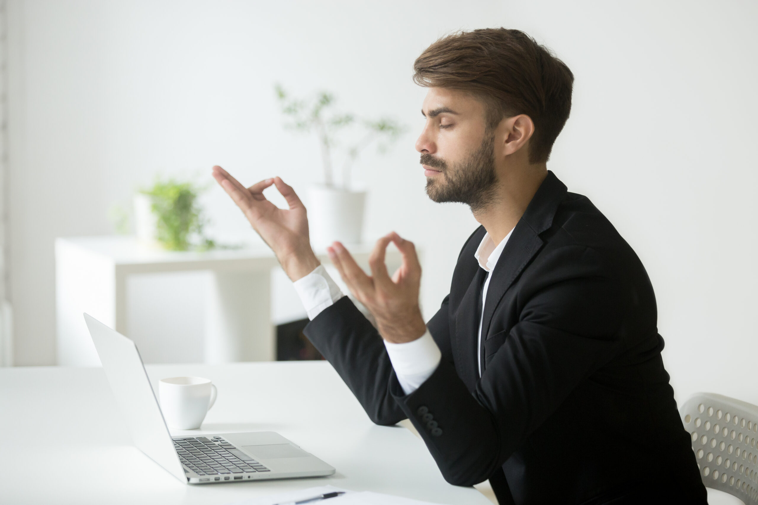 mężczyzna medytuje przy biurku